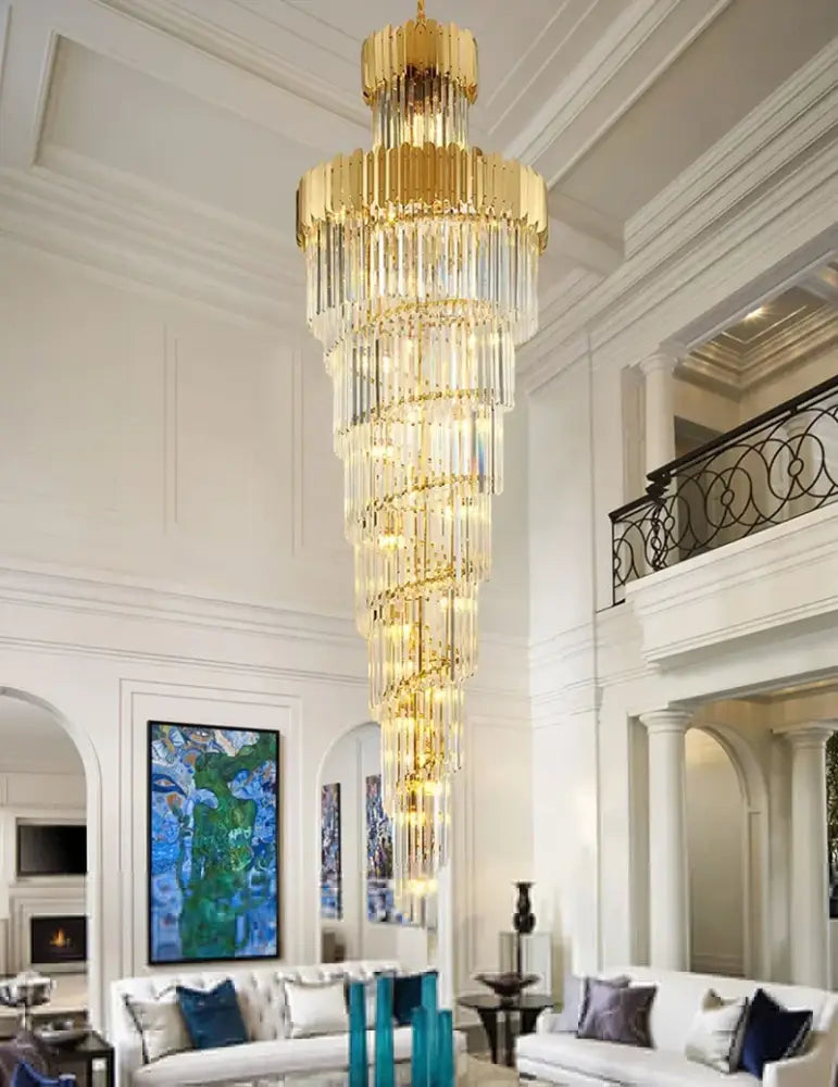 A golden luxury spiral multi-tier chandelier with cascading clear crystal prisms for decorbites golden luxury decor