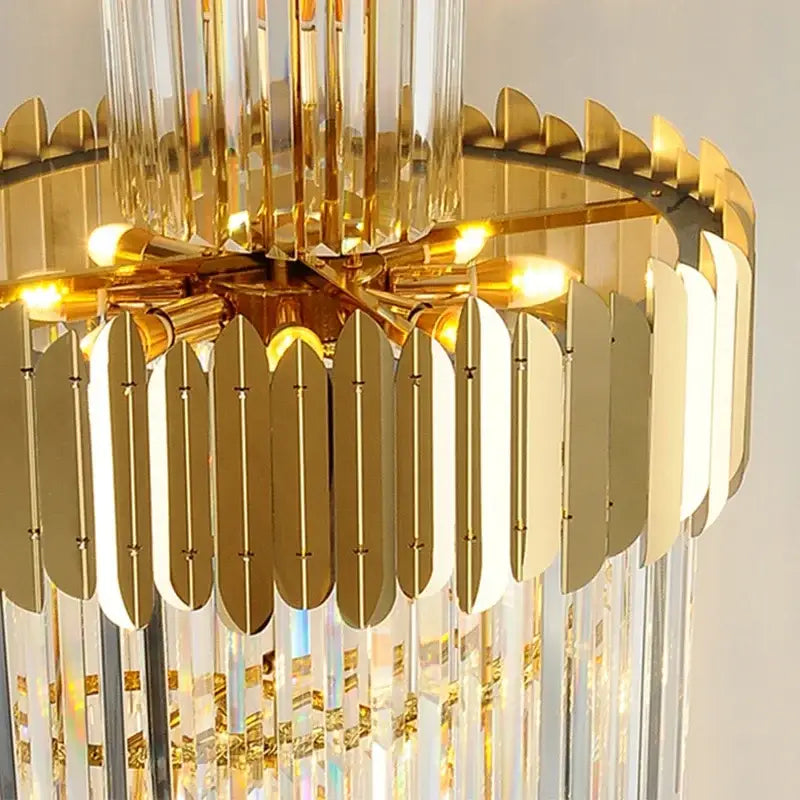 Golden luxury spiral crystal chandelier with gold-toned finish crystal prisms and metallic leaf-shaped accents decorbites golden luxury