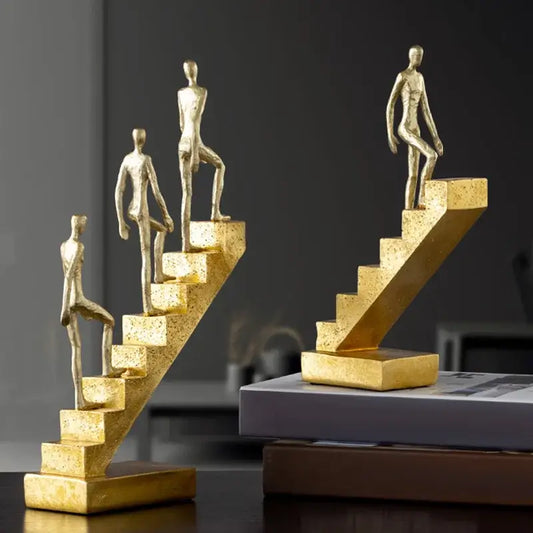 Golden man abstract resin staircase sculpture featuring golden metallic figurines ascending stairs for living room decorbites decor