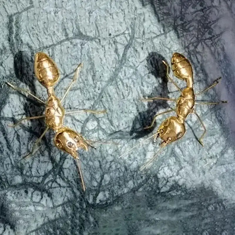 Golden metal ants decorative figurines with intricate detailing and polished finish for elegant home decor