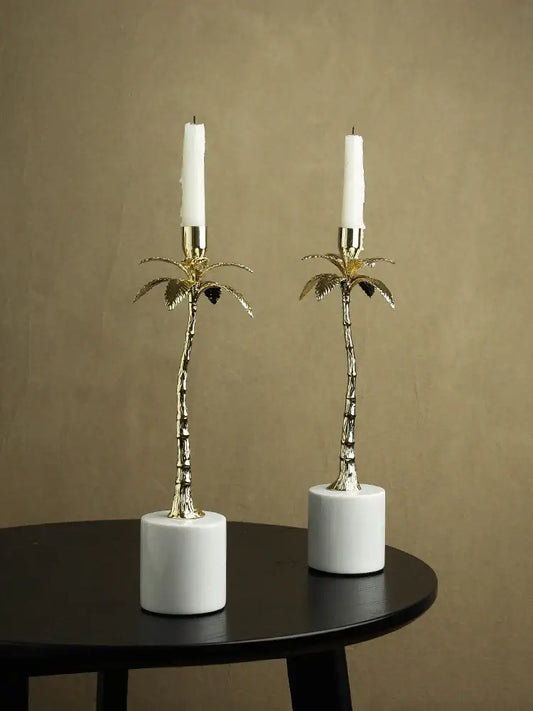 Golden metal candlestick palm tree candle holders with white marble bases and tall white candles for home decorbites decorbites golden metal home decor