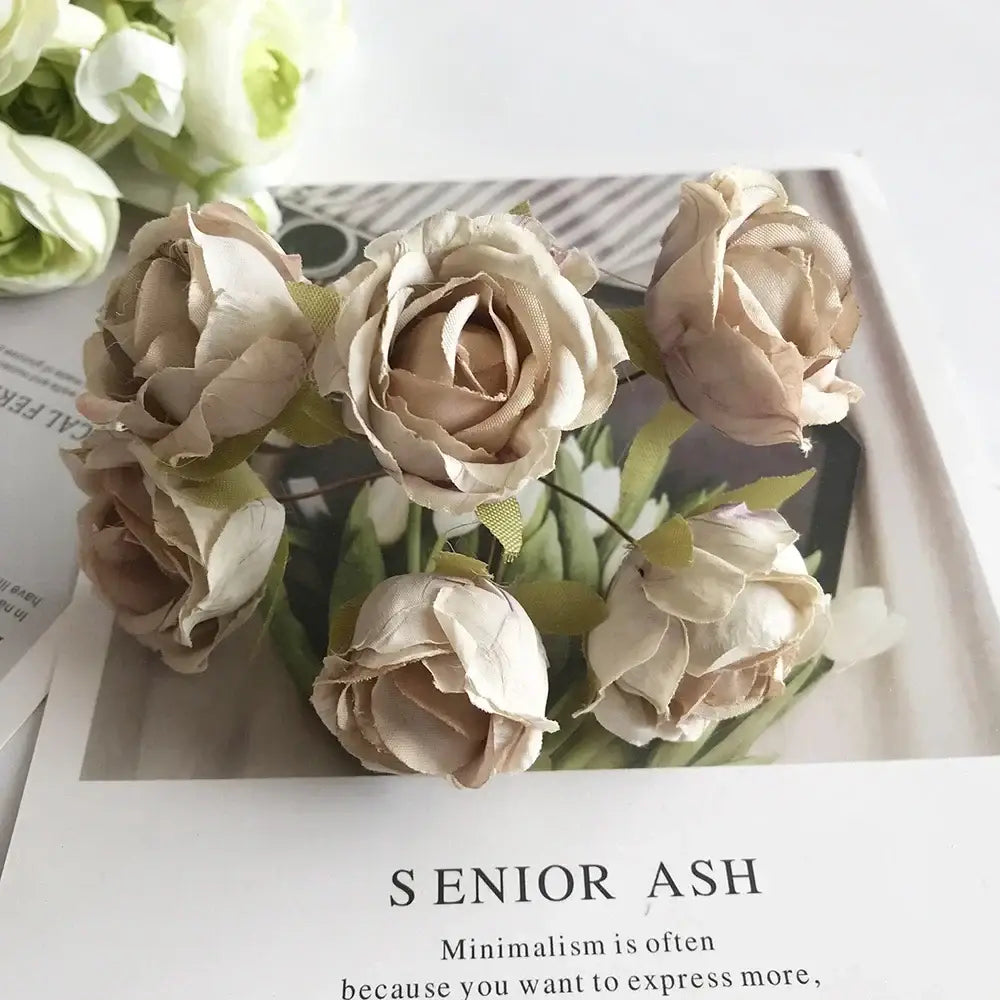 A delicate golden metallic berry stamen green plant foliage with beige fabric roses for decorbites green plant decor