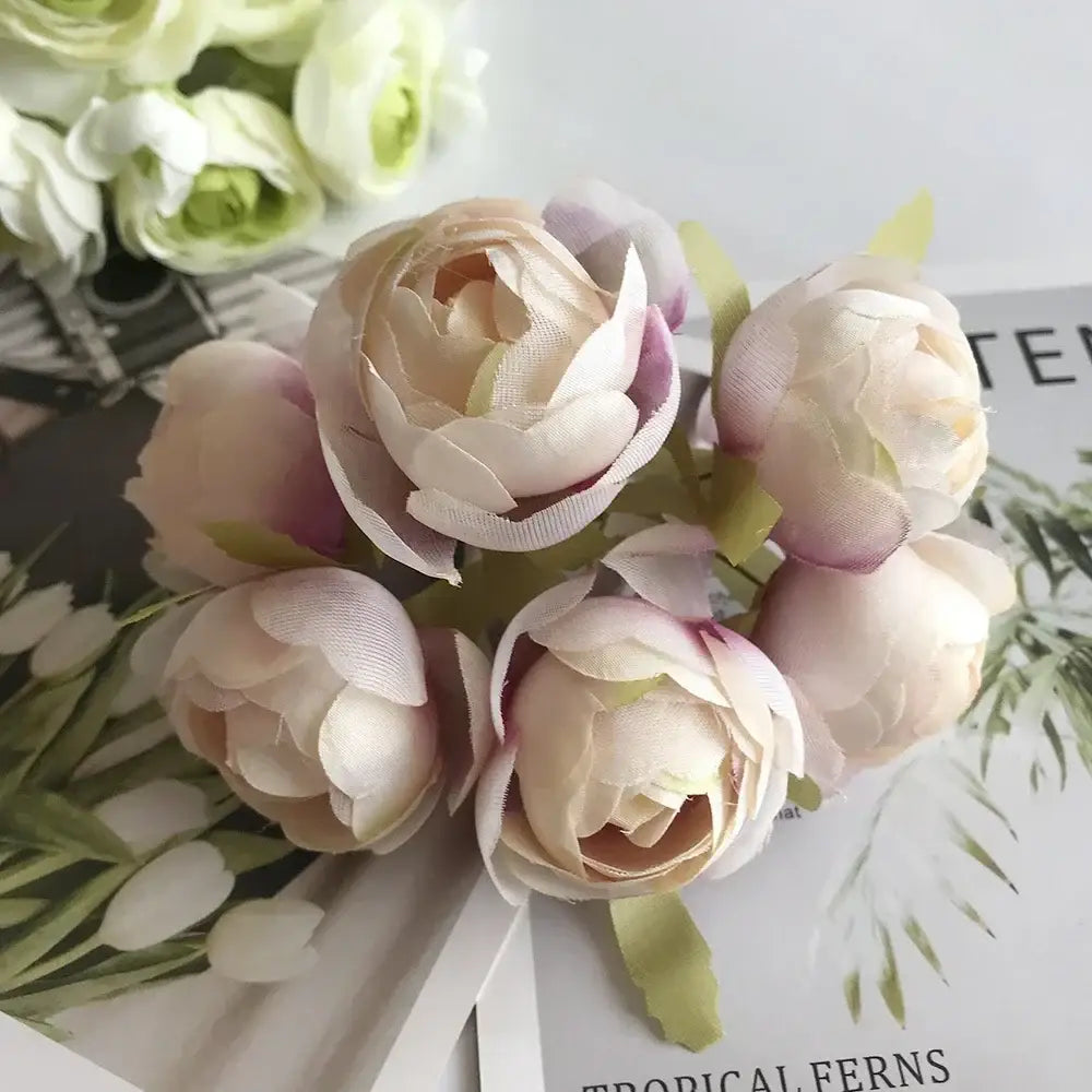 A delicate bouquet of fabric blush and cream peonies with golden metallic berry stamen green plant foliage decorbites green plant