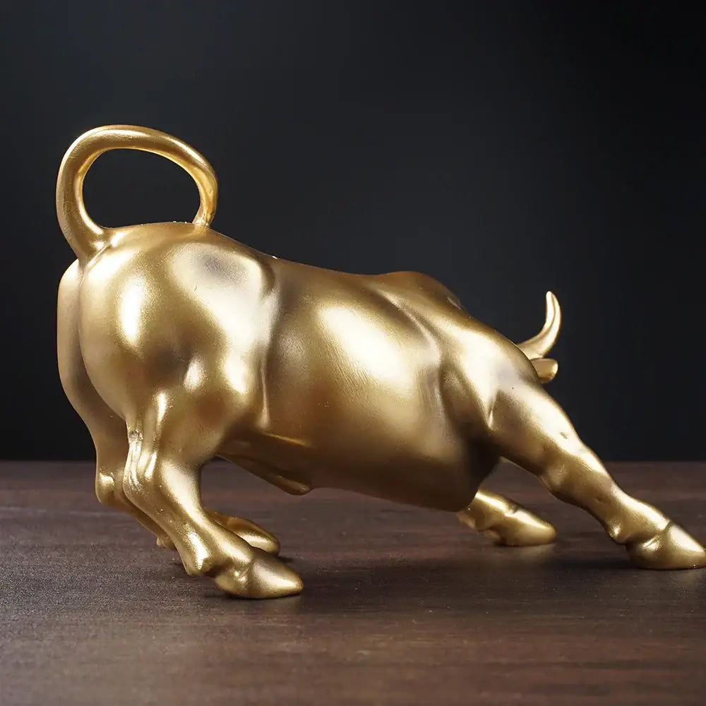 Golden metallic bull figurine with curved tail ring and detailed musculature for living room feng shui decorbites bull figurine