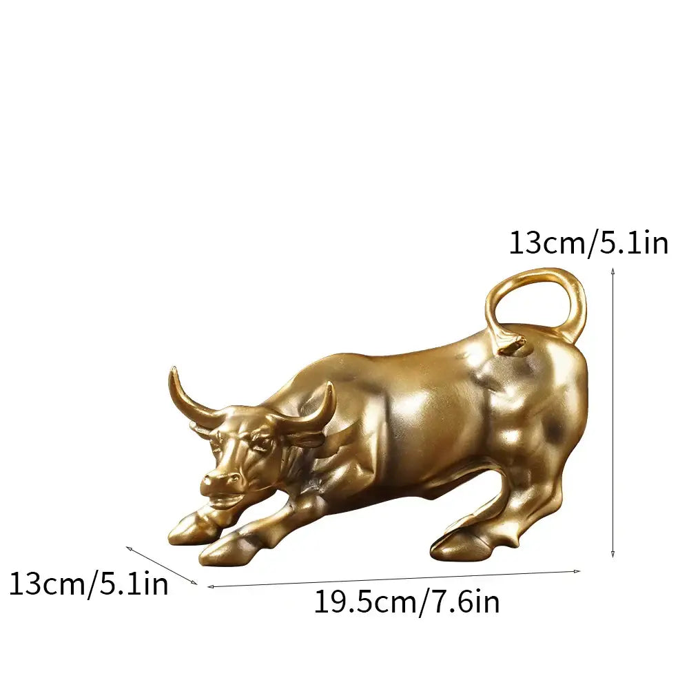 Golden metallic bull figurine with detailed musculature and looped tail for living room feng shui decor by decorbites bull