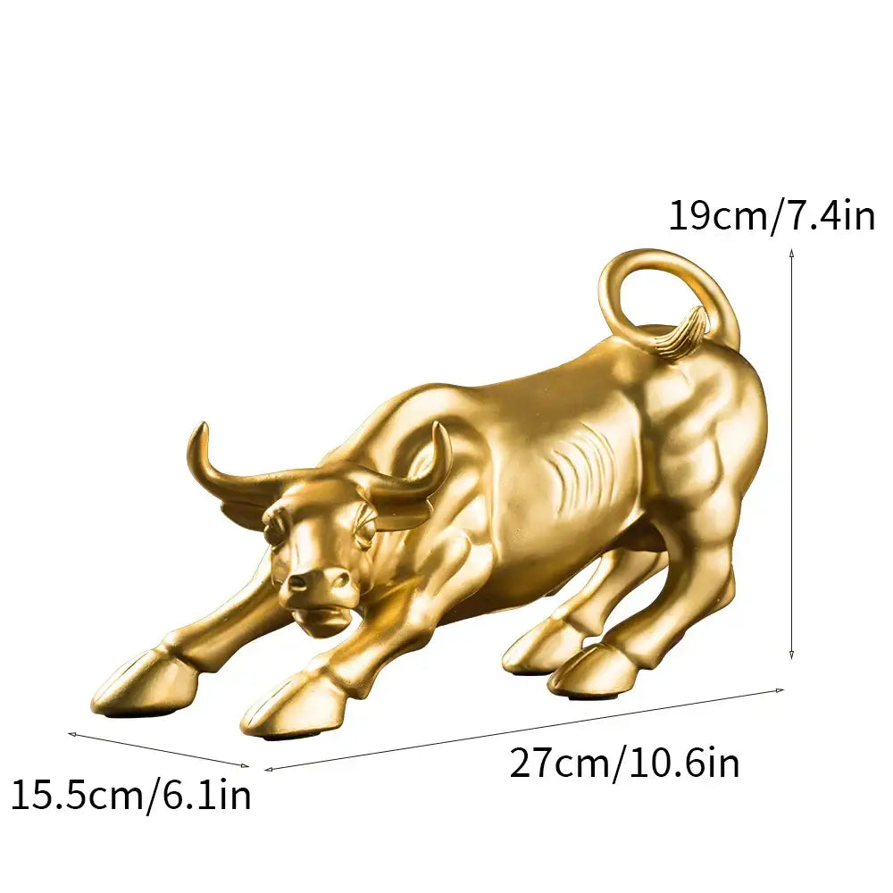 Golden metallic bull figurine by decorbites with detailed musculature and curled tail in dynamic charging pose for living room decor