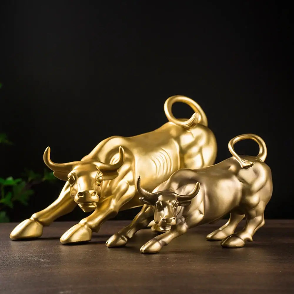 Golden metallic bull figurine with detailed musculature and curled tails for living room feng shui decor by decorbites