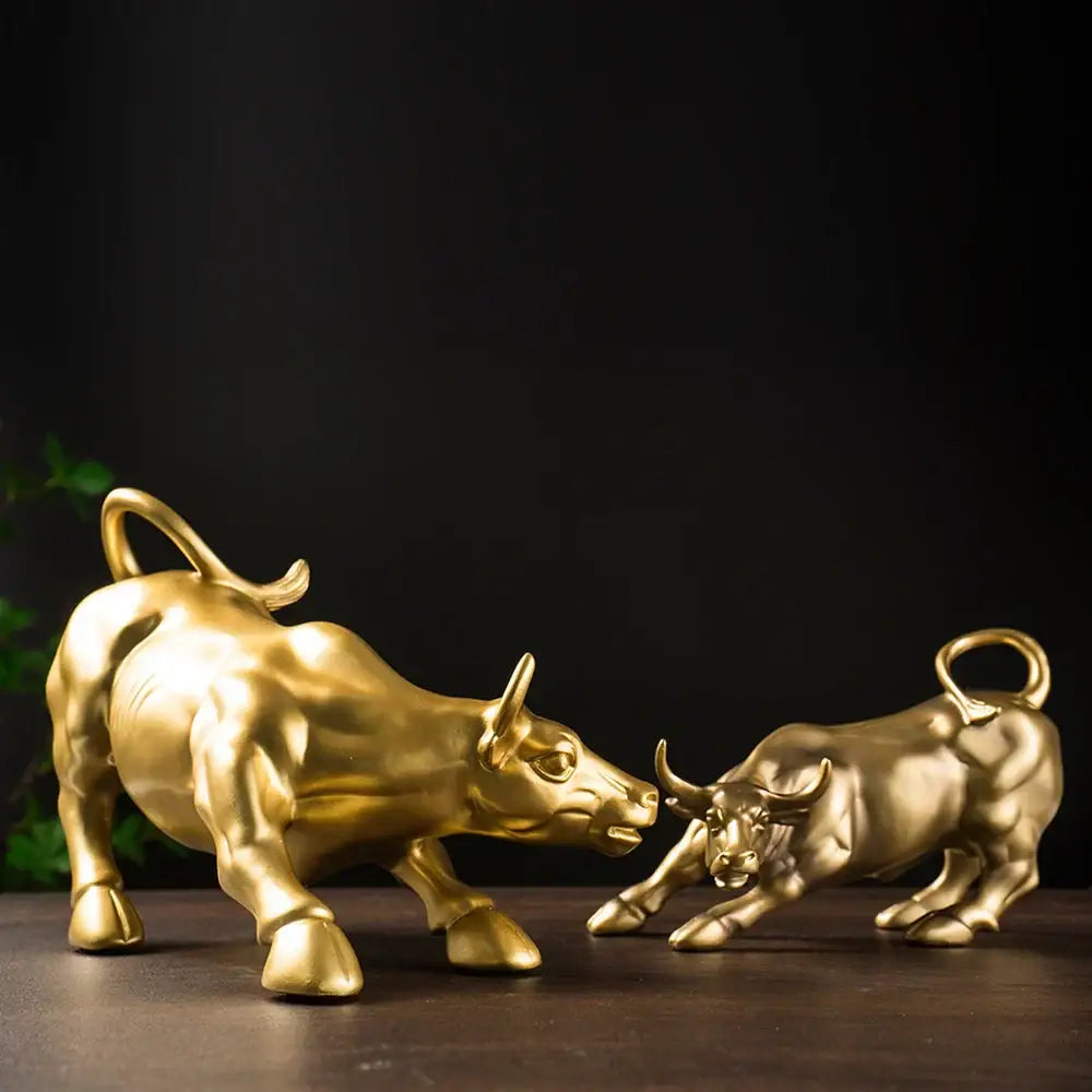 Golden metallic bull figurine with detailed musculature and curved horns in dynamic confrontation for living room feng shui decorbites bull figurine