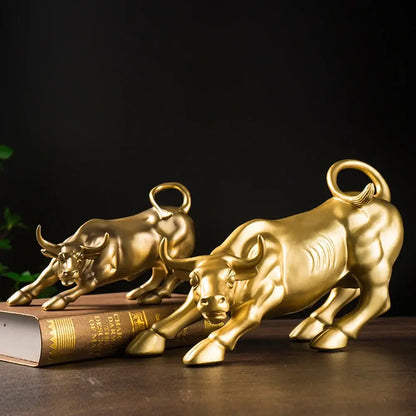 Two golden glossy resin bull figurines with detailed musculature and curled tails for living room feng shui decorbites bull figurine