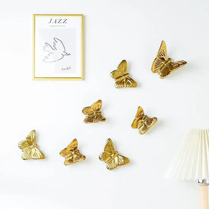 Gold-colored ceramic butterfly wall decoration set featuring metallic finish for living room wall decor set