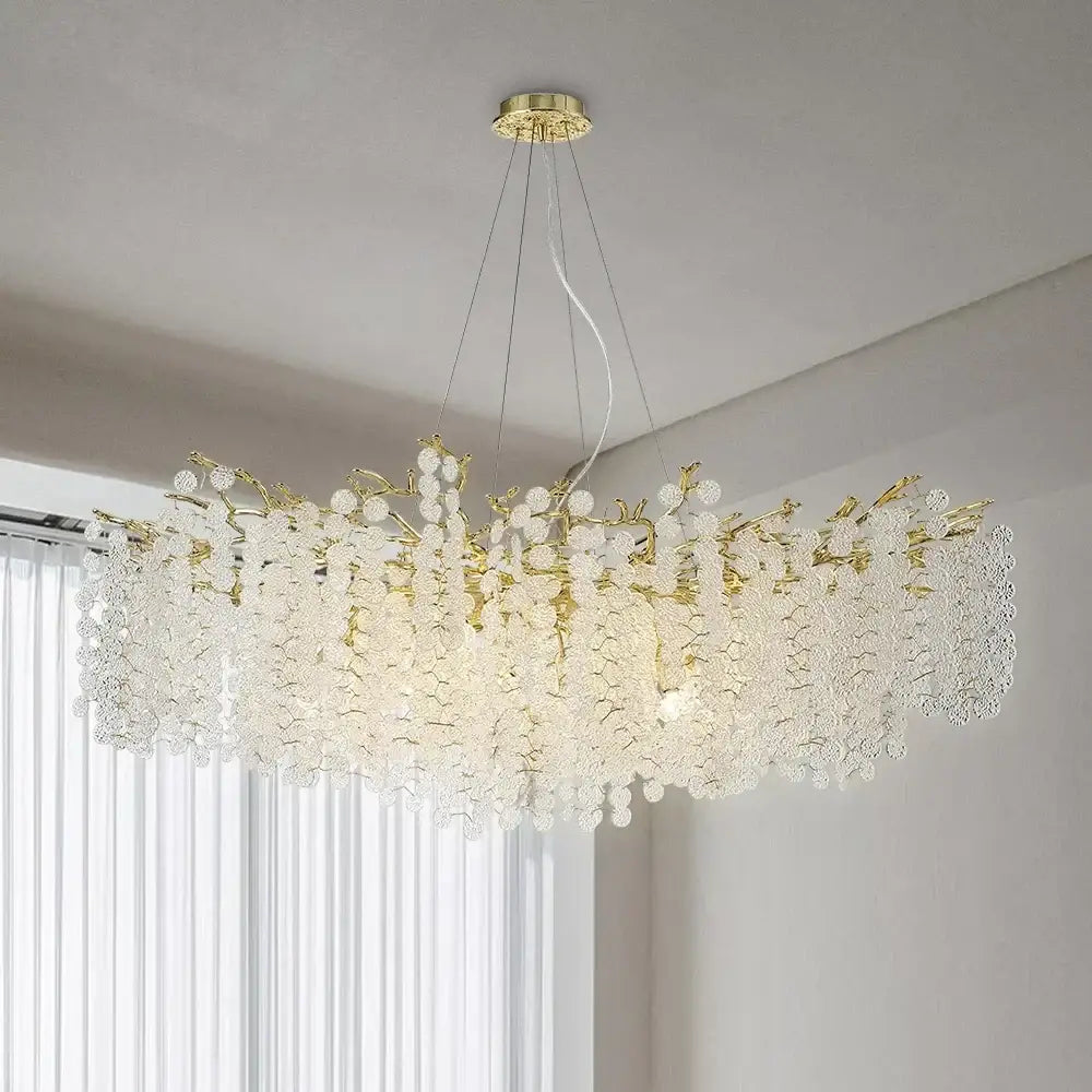 A gold-toned crystal chandelier with blossom-like clusters resembling a golden money tree pendant light for living rooms