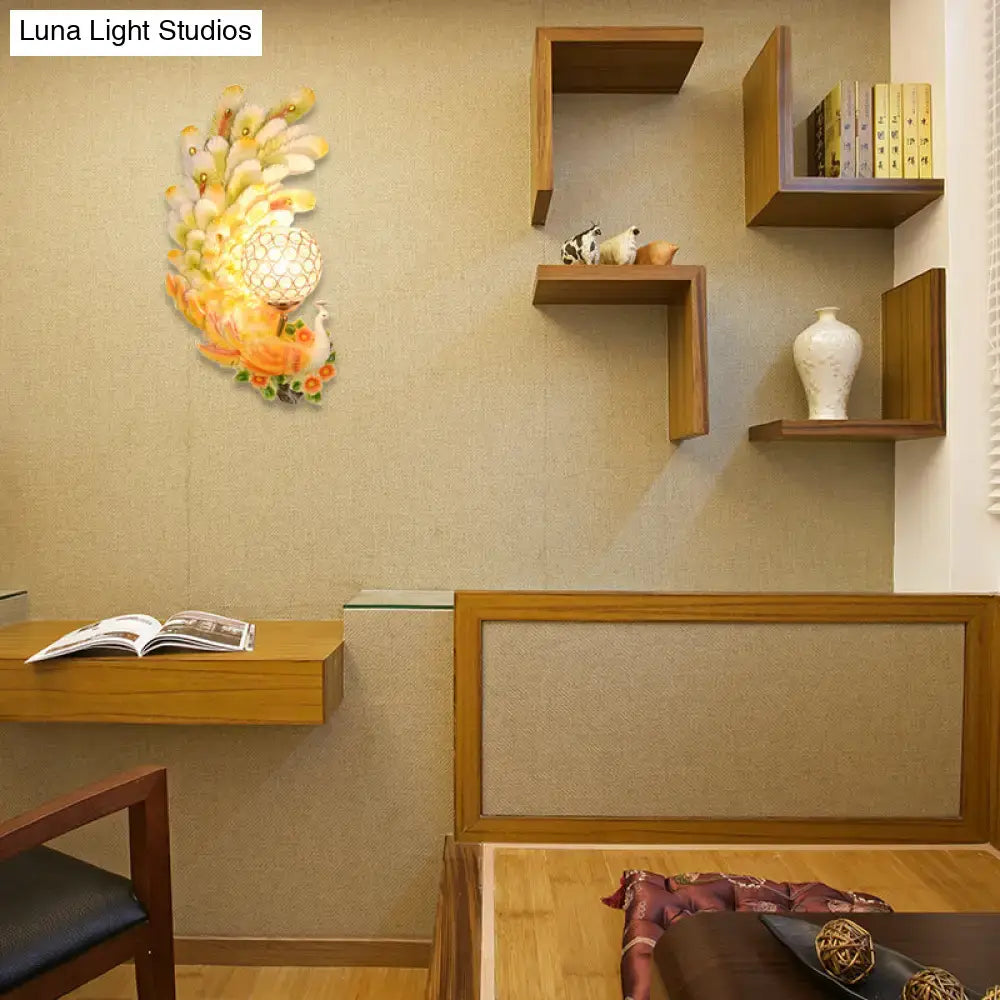 Golden peacock wall light with crystal shade featuring vibrant orange yellow and white feathers for yellow green decor