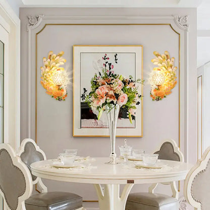 Golden peacock wall light with crystal shade yellow green features floral petal design flanking botanical artwork in dining room
