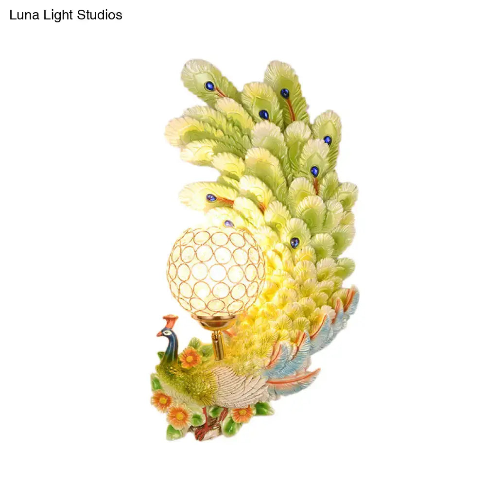 Golden peacock wall light with crystal shade featuring yellow green feathers and orange flowers for living room decor
