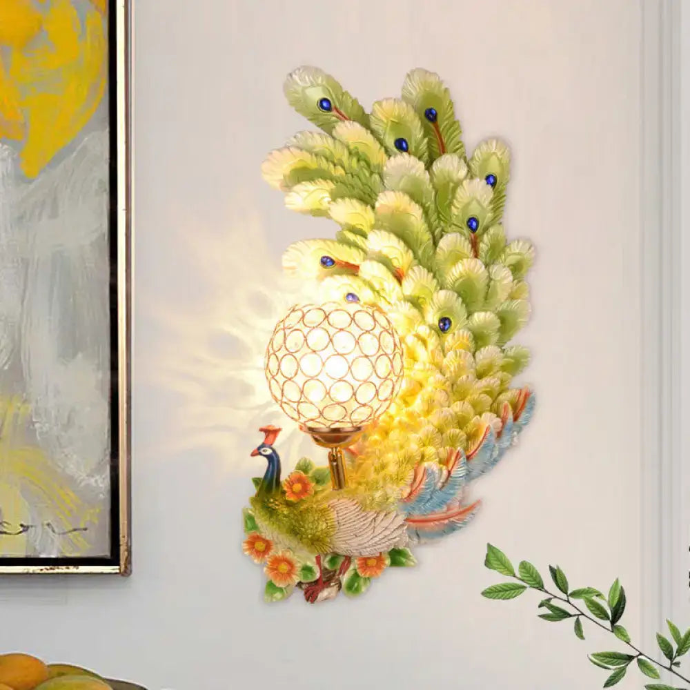 Golden peacock wall light with crystal shade featuring vibrant yellow green feathers and blue gemstone accents for living room use