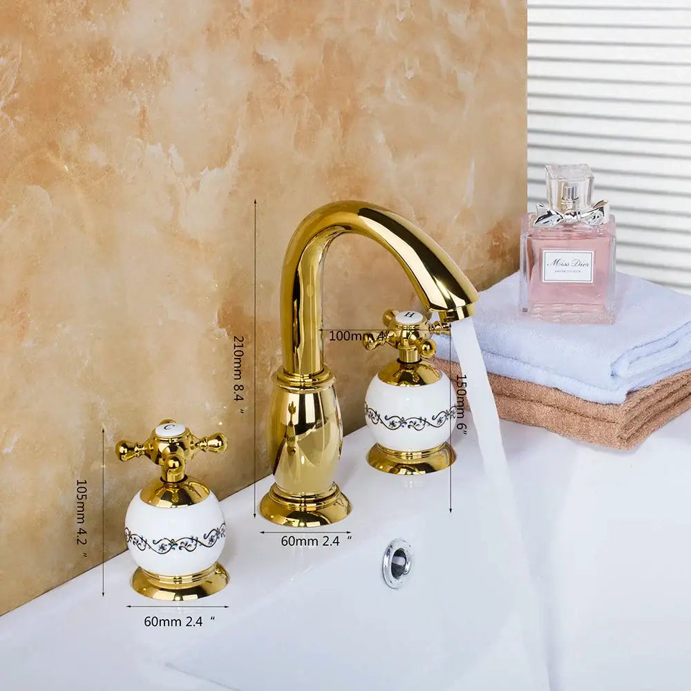 Golden plated bathroom faucet set with white ceramic handles featuring black floral detailing by decorbites golden plated