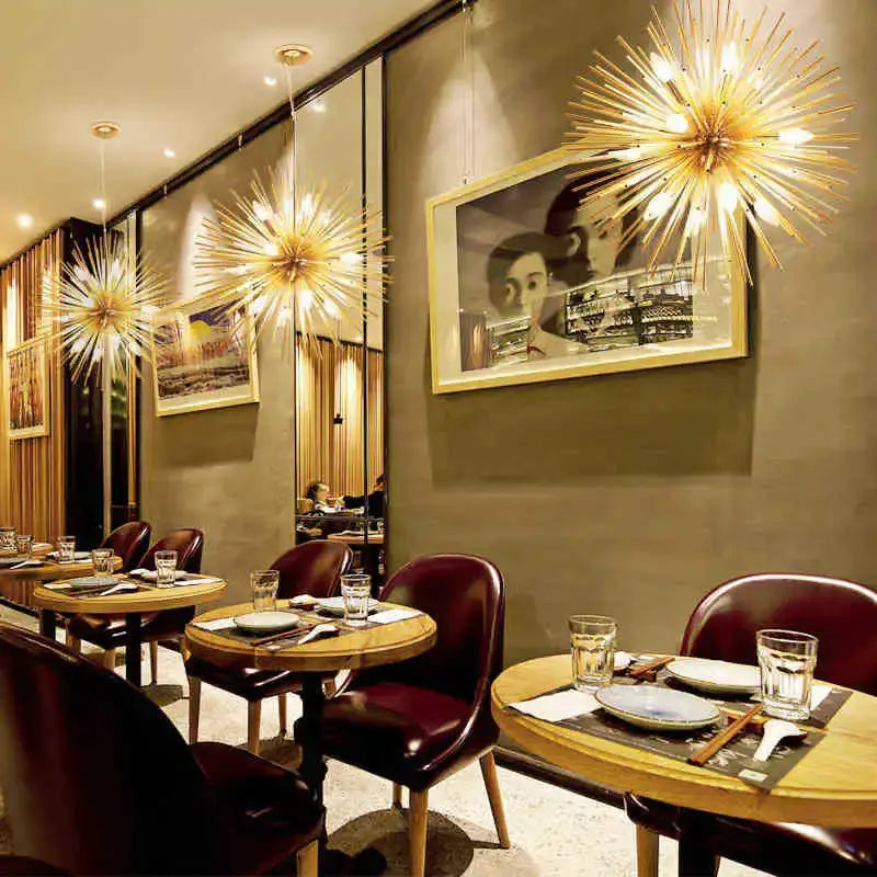 Golden starburst ball pendant lamp with intricate metallic arms radiating light for living room decorbites golden ball