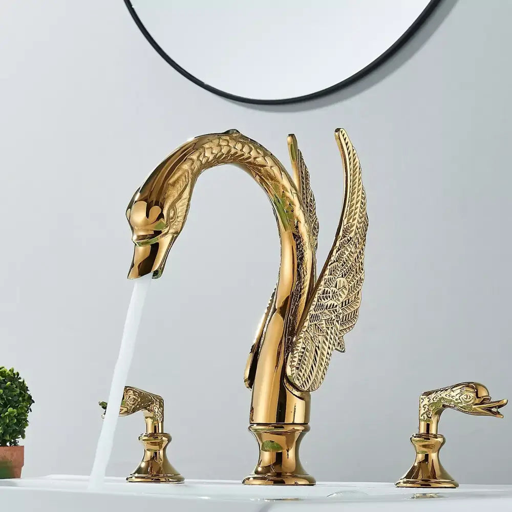 Golden swan dual handle deck mounted bathroom basin tap with intricate feather detailing and cold water handles