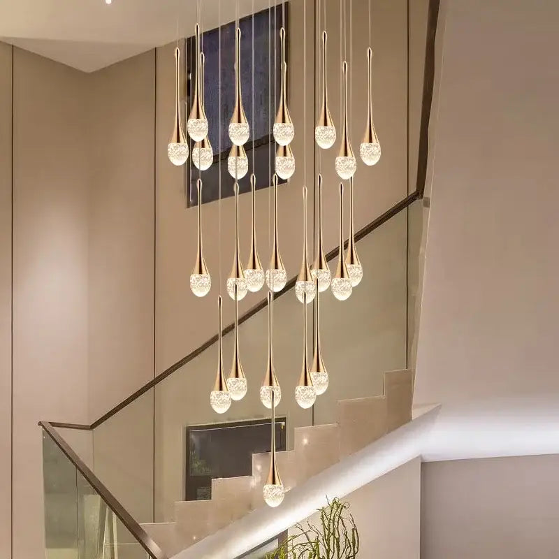 Modern gold-toned pendant lights with teardrop crystal bubble ball globes for elegant dining room decorbites crystal bubble design