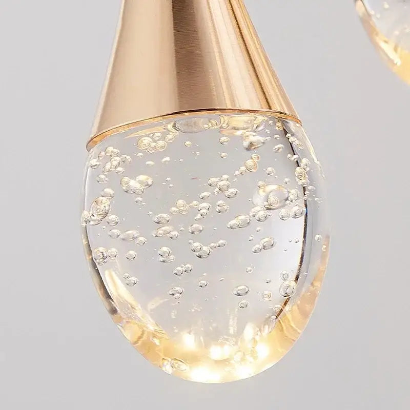Golden teardrop pendant light with brushed gold metal top and bubble ball glass design for dining room decorbites crystal bubble decor