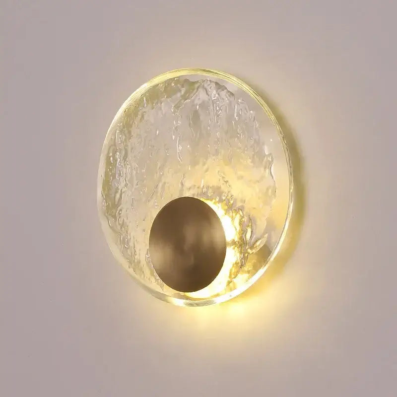 A modern wall lamp with a warm golden base and textured translucent glass shade for elegance crystal wall lighting