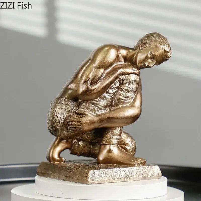 Bronze-colored resin sculpture of a muscular crouching man golden thinker bodybuilder for office desk decor
