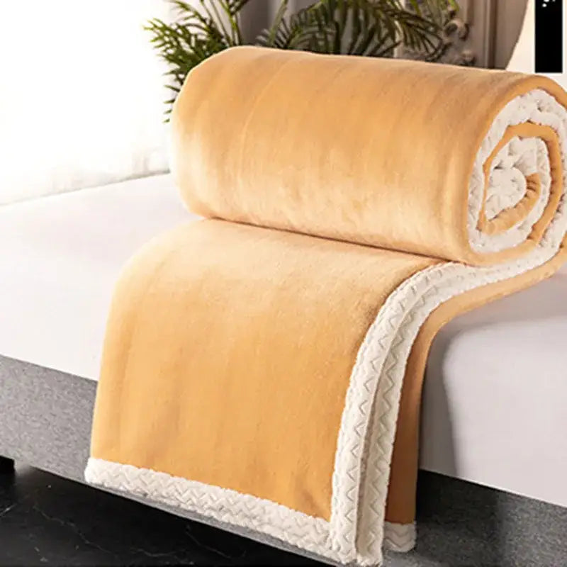 A cozy mustard yellow double-layer velvet sofa blanket with white sherpa lining and decorative zigzag stitching edge