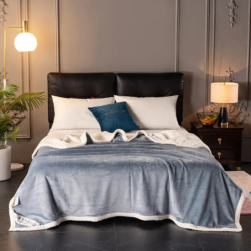 A plush blue double-layer velvet sofa blanket with a white fleece border for bedroom throws