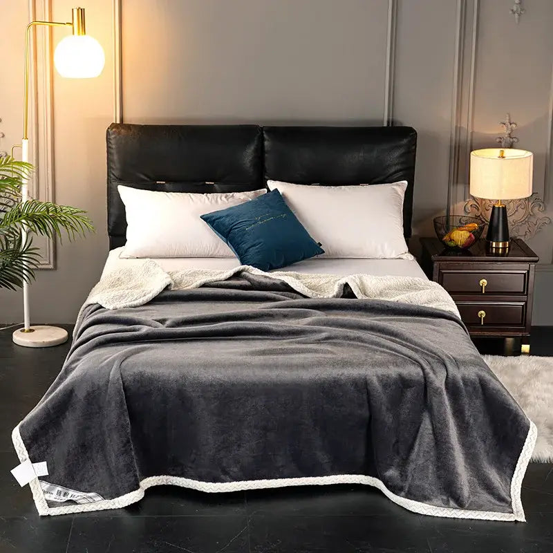A plush dark gray velvet sofa blanket with white fleece trim double-layer velvet design for sofa or bedroom throw