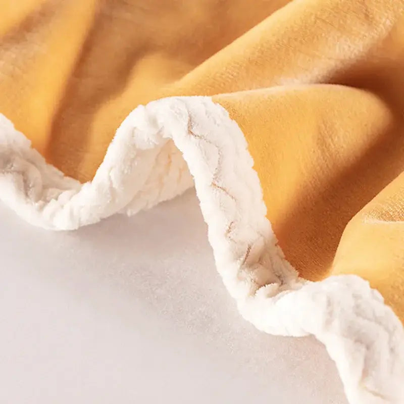 Soft mustard-yellow double-layer velvet sofa blanket with plush white sherpa trim for bedroom throw use