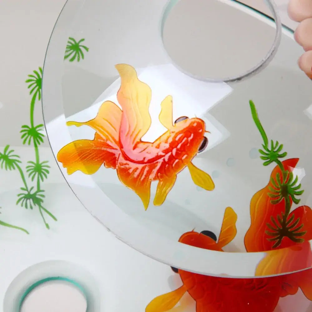 Decorbites goldfish glass waterfall faucet features a vibrant orange and yellow goldfish design on clear curved glass plate