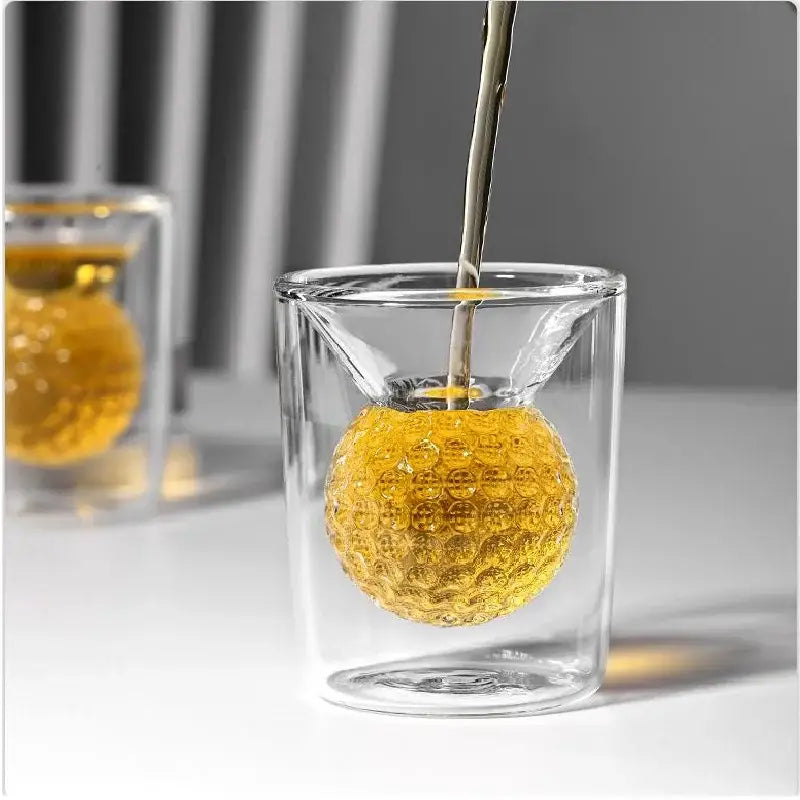 Clear double-walled golf ball double tumbler glass cup with golden textured spherical tea infuser for decorbites golf ball decor