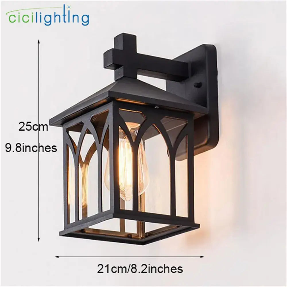 Black wrought iron gothic arched led wall lamp with clear glass panels and visible filament bulb for outdoor use