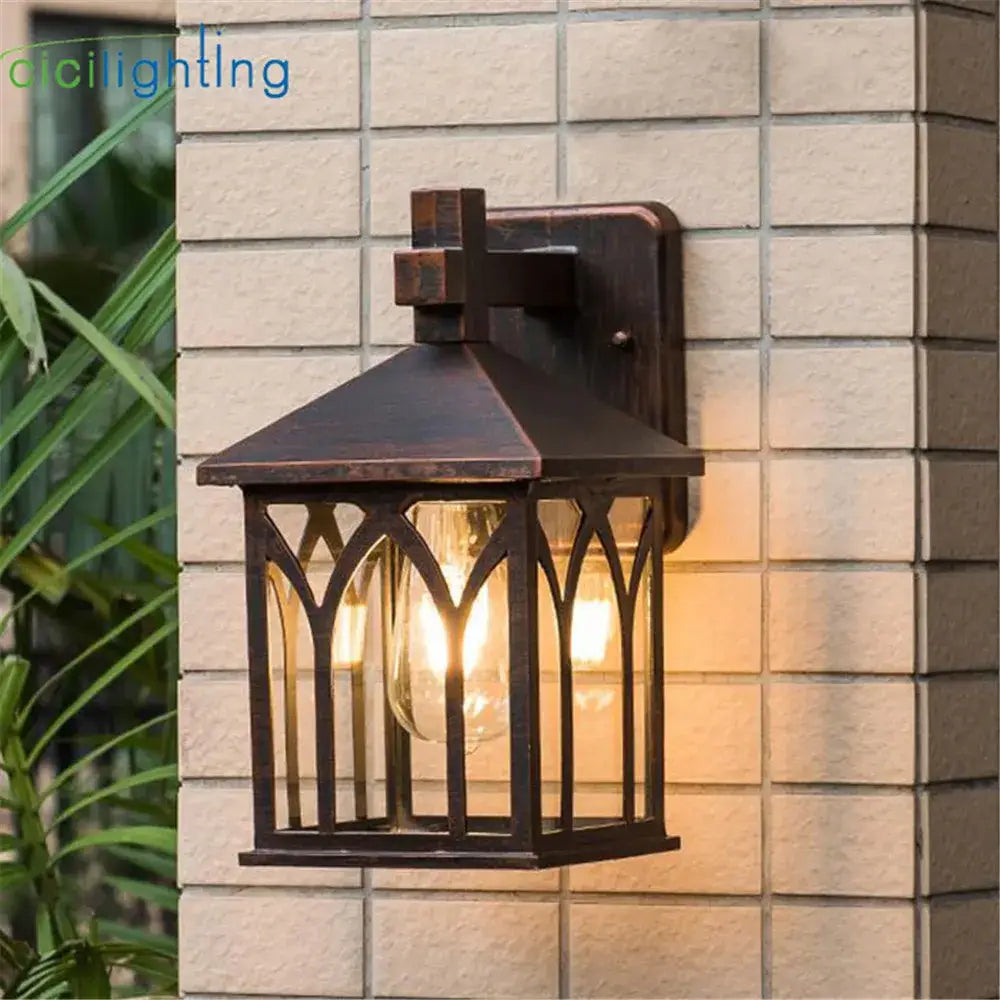 Bronze-finished wrought iron gothic arched glass led wall lamp with clear panels for garden courtyard lighting