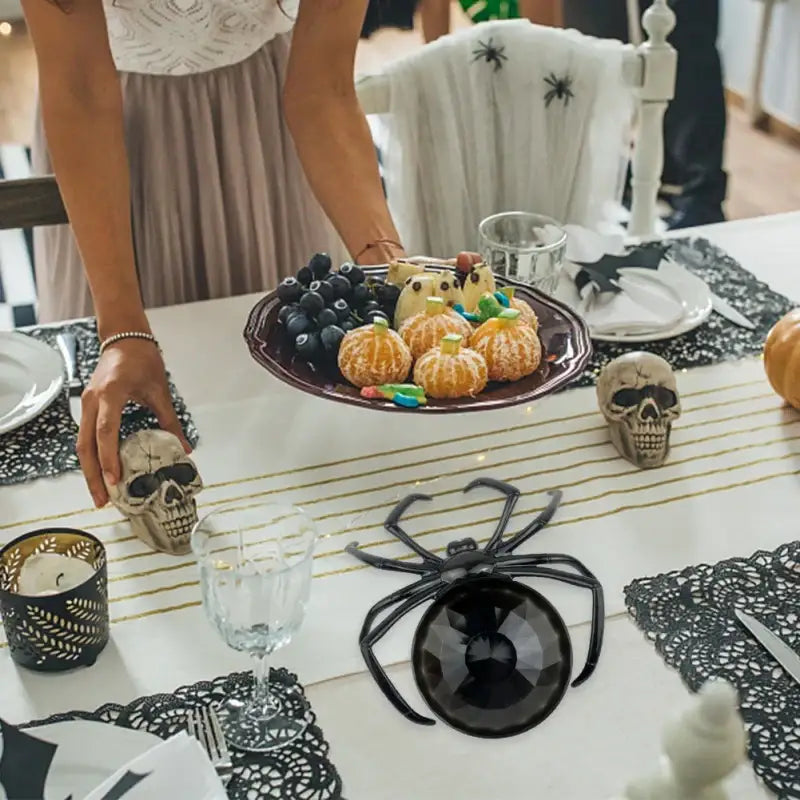 Black plastic skull spider tray with faceted black orb centerpiece used as gothic gemstone storage plate
