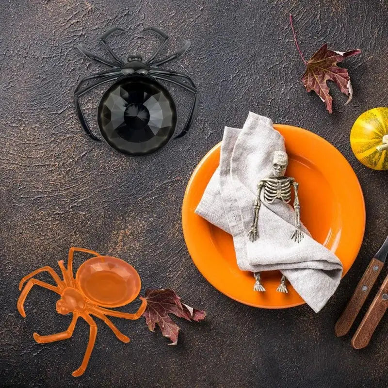 Black plastic skull spider tray with faceted glossy center serving as gothic gemstone storage plate
