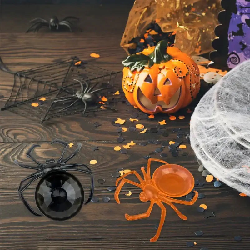 Orange glossy translucent plastic spider with detailed legs on gothic gemstone skull spider tray storage plate