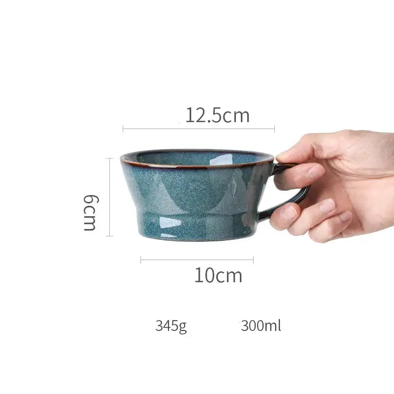 A beautiful blue ceramic bowl with gold rim and a speckled teal ceramic mug with black handle dinnerware dish set