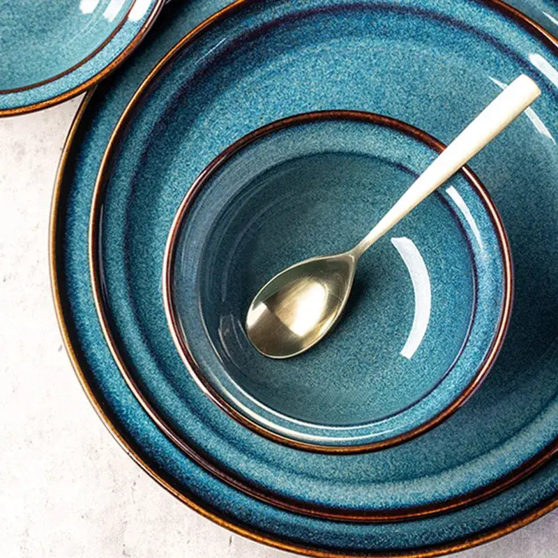 Set of beautiful blue ceramic dinnerware dish with gold rim bowl and plate featuring a textured glaze finish