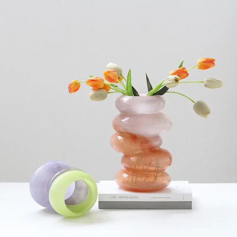 A translucent stacked gradient color decorbites geometric glass vase in soft pink to warm orange for living room decor