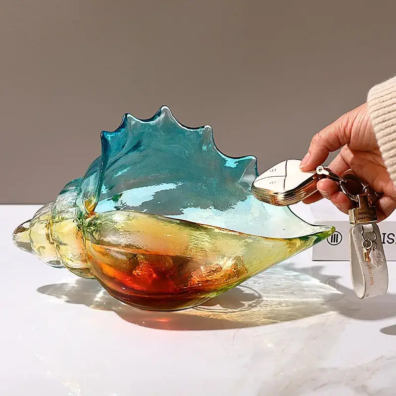 A vibrant translucent glass key tray with blue yellow and orange hues from decorbites conch glass handicrafts