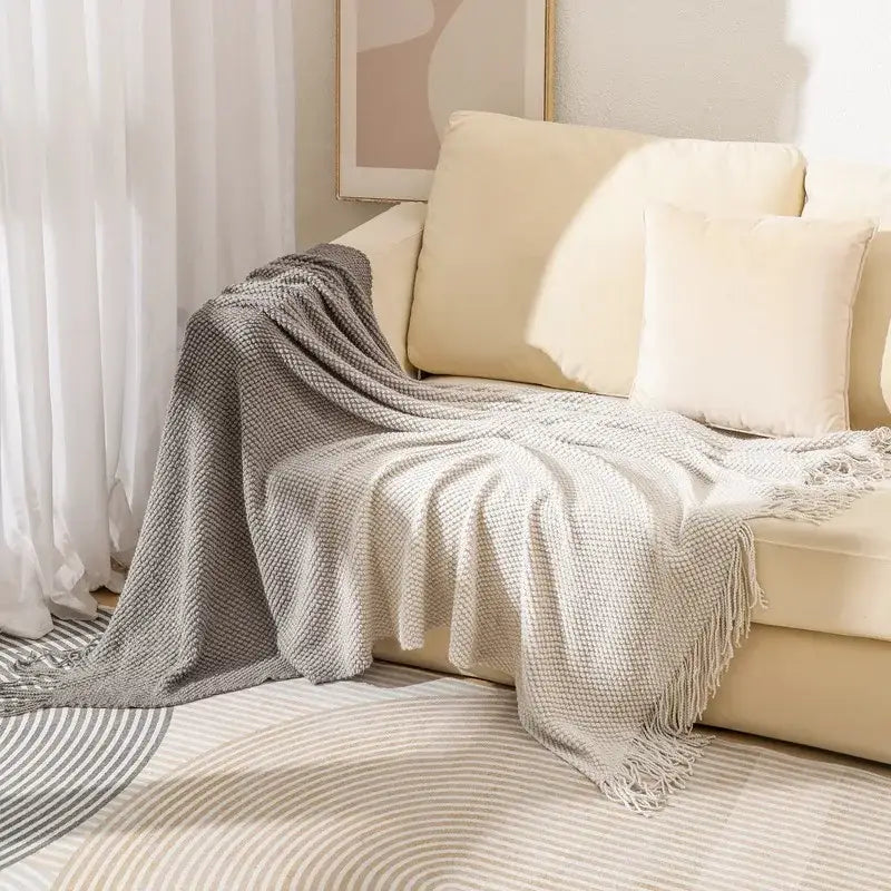A soft gray knit blanket with woven gradient pineapple grid pattern and fringed edges for bedroom decorbites throw