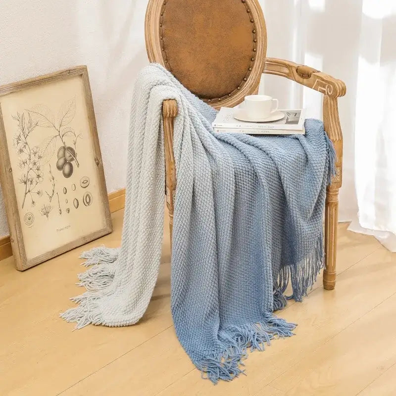 Soft gradient blue knit blanket with fringed edges draped on wooden chair decorbites gradient pineapple grid throw