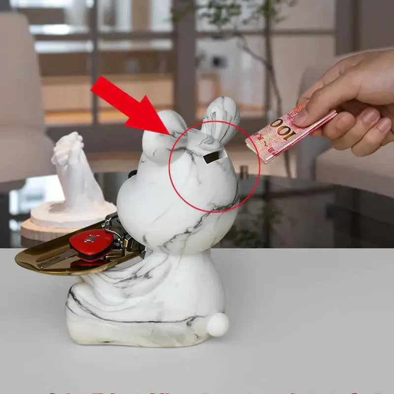 White marble-patterned rabbit-shaped money box with black slot and gold tray holding keys for decorbites graffiti bear figurine storage