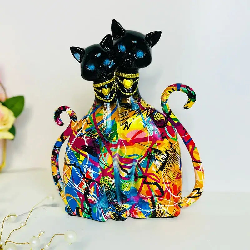Vibrant abstract-painted ceramic decorbites cat couple sculpture with glowing blue eyes and gold-trimmed necklaces for decor