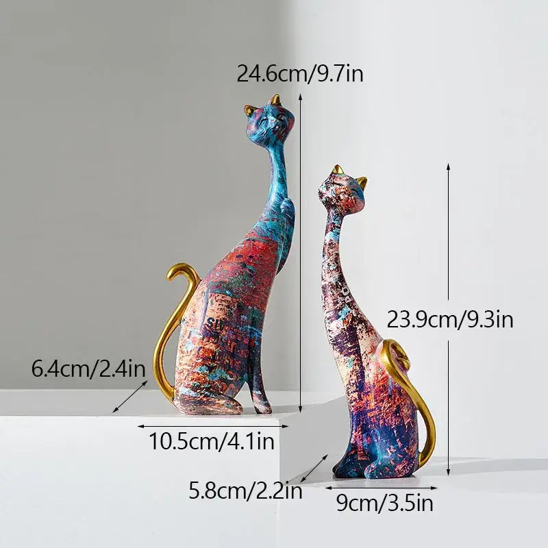 Two abstractly painted blue red and purple cat lovers resin figurines with gold-tipped ears and tails decorbites cat lovers