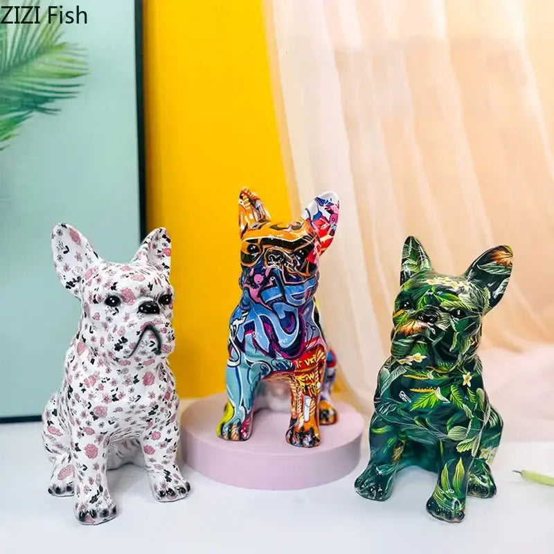 Three colorful decorbites bulldog punk art resin sculptures in pink floral, graffiti, and green tropical leaf patterns for decor