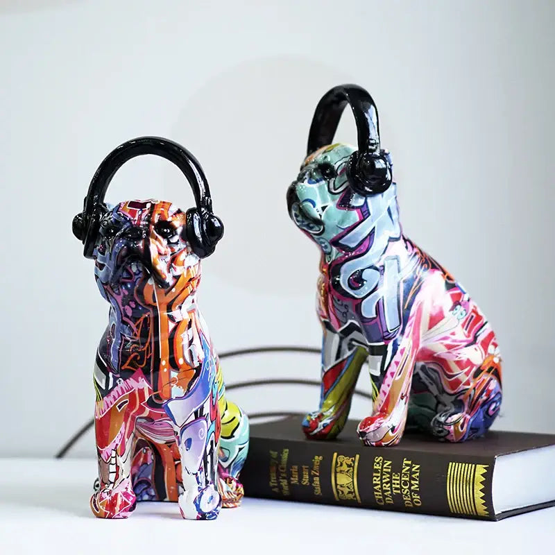 Two vibrant graffiti resin bulldog headphone figurines with black headphones for living room decor
