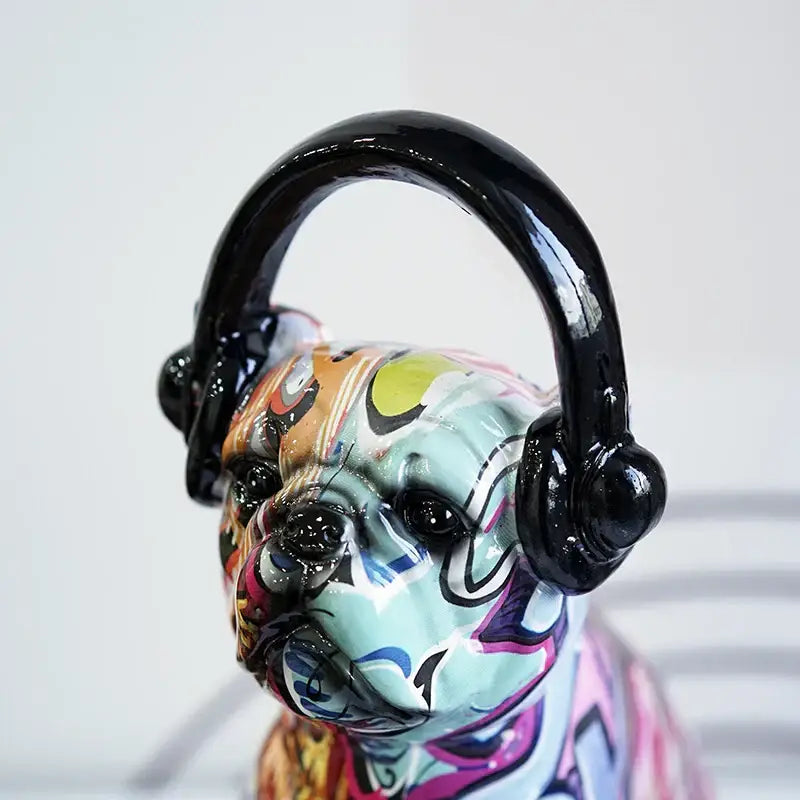 A vibrant graffiti resin bulldog headphone figurine in bright colors wearing glossy black headphones for living room decor