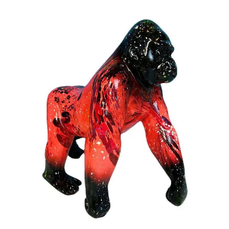 Glossy resin decorbites gorilla sculpture with vibrant red speckled body and solid black head and feet for living room decor